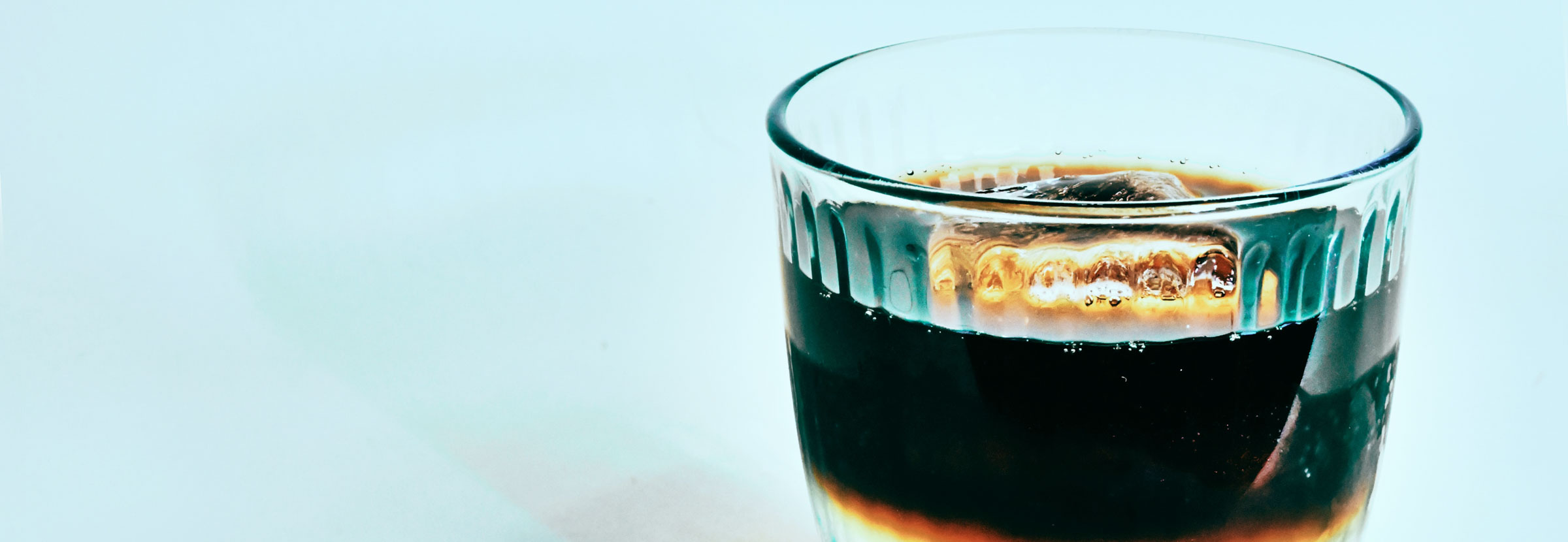 A glass filled with a cold coffee beverage.